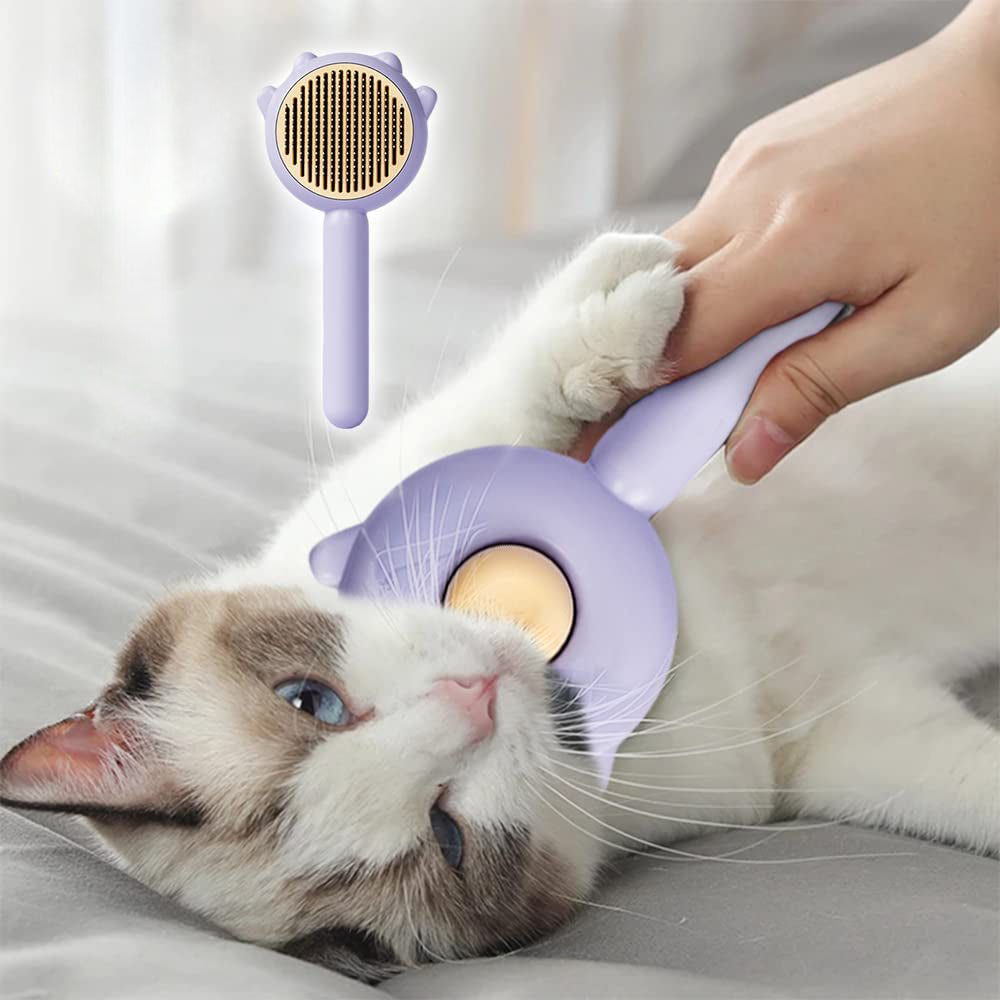 Person using a purple pet grooming tool on a lying cat