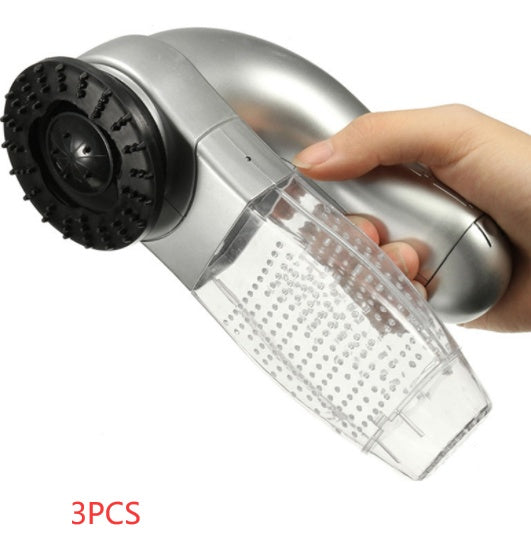 Handheld vacuum cleaner with clear dustbin and black brush head, held by a hand on a white background.