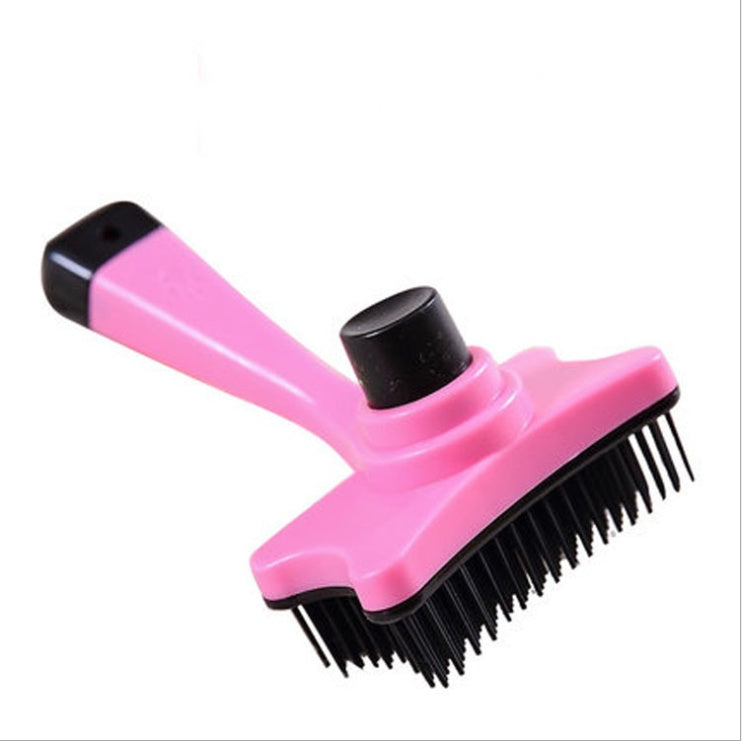 Pink pet grooming brush with black bristles on a white background