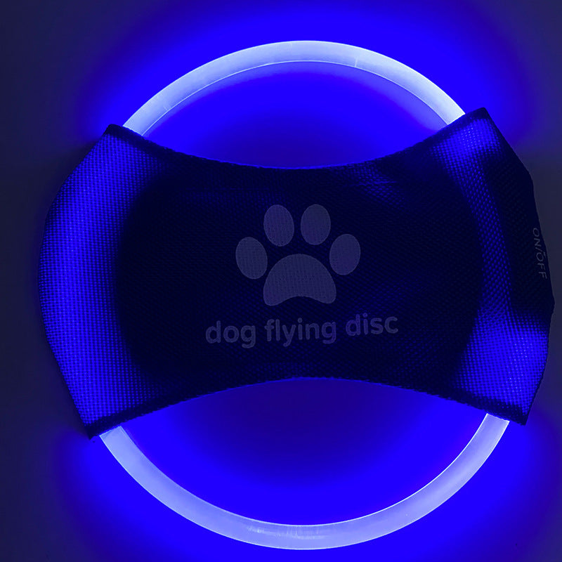 Blue dog flying disc with paw print design on a dark background