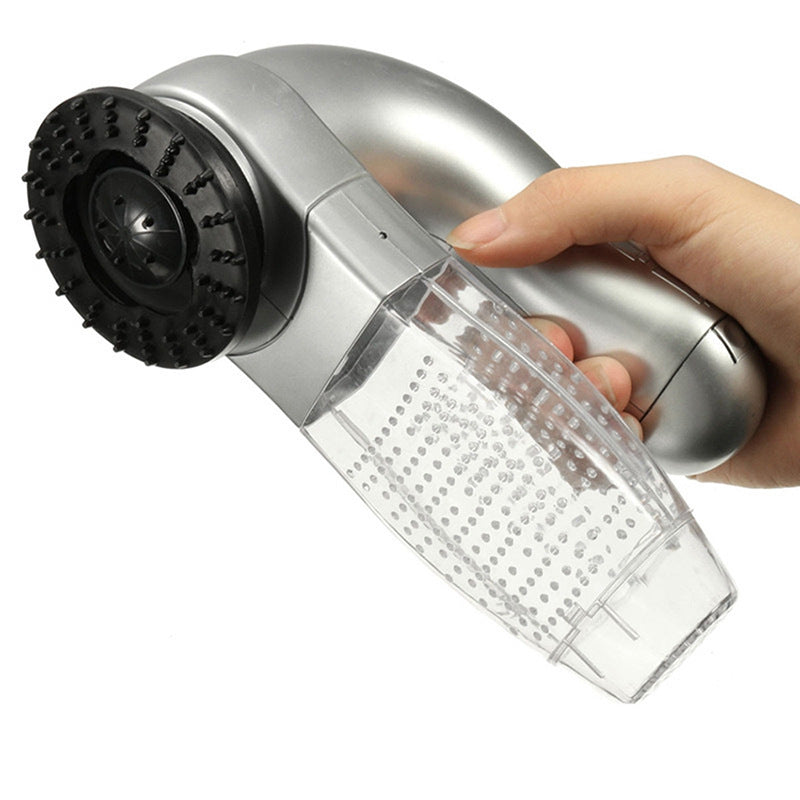 Handheld vacuum cleaner with clear dustbin and black brush head held by a hand on a white background