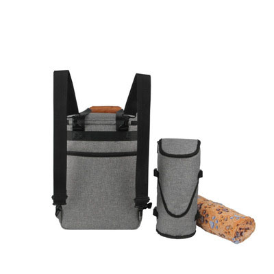Gray backpack with a smaller cylindrical bag and rolled-up mat on a white background