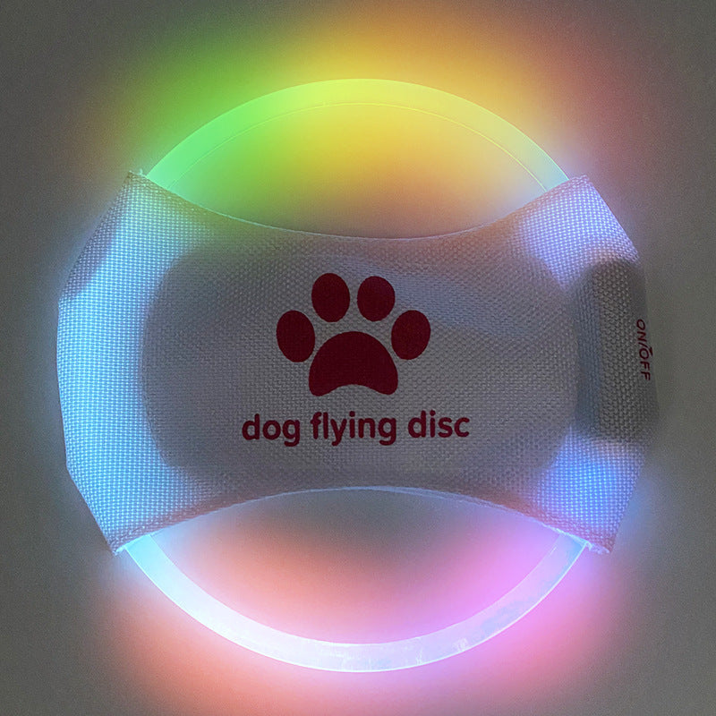 Multi Colorful LED dog flying disc with a paw print logo on a dark background
