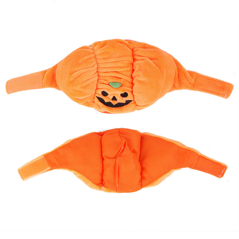 Two orange pumpkin-shaped doggy diapers with a smiling face design on a white background.