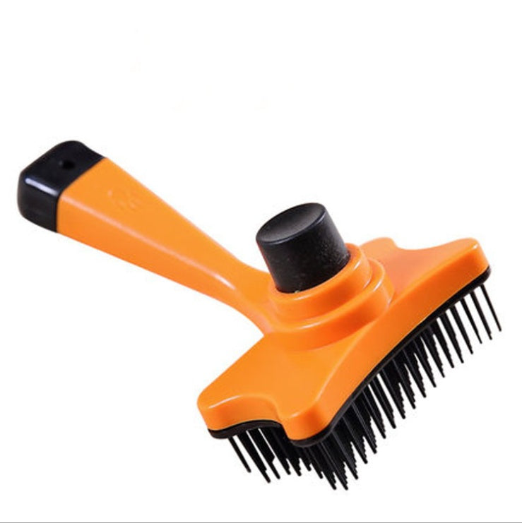 Orange grooming brush with black bristles on a white background
